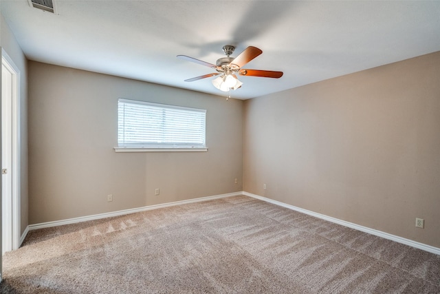 carpeted empty room featuring visible vents, baseboards, and ceiling fan