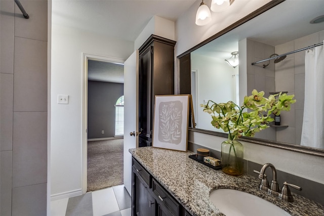 bathroom featuring a shower with curtain, baseboards, and vanity