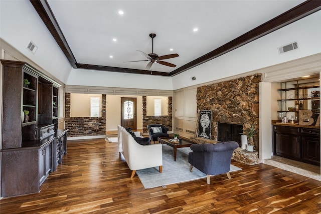 living room featuring a fireplace, wood finished floors, and visible vents