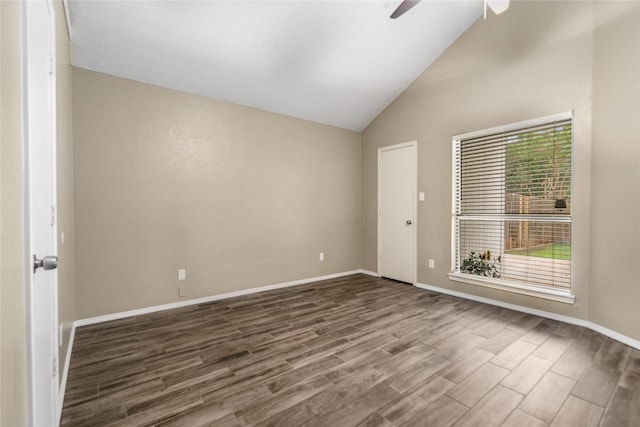 empty room featuring baseboards, a ceiling fan, high vaulted ceiling, and wood finished floors