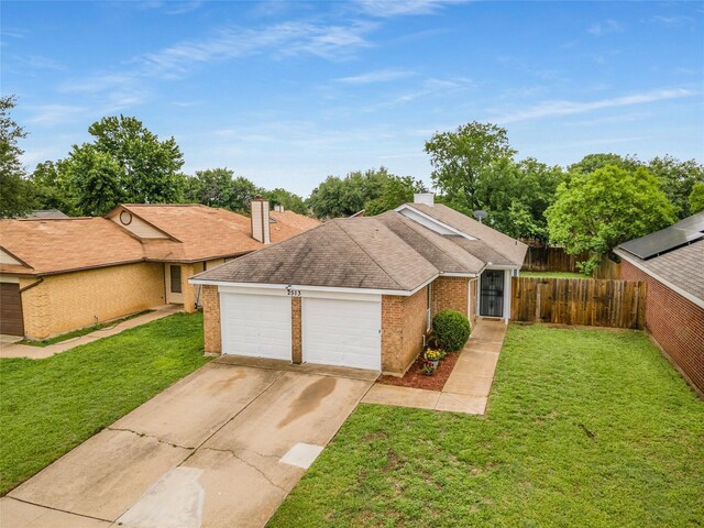 view of front of home with fence, an attached garage, concrete driveway, and a front yard