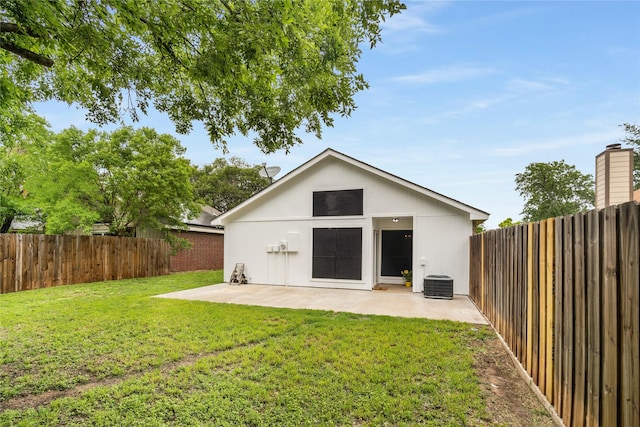 exterior space featuring a lawn, a patio, a fenced backyard, and central AC