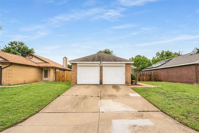 view of front of home featuring brick siding, a garage, fence, and a front yard