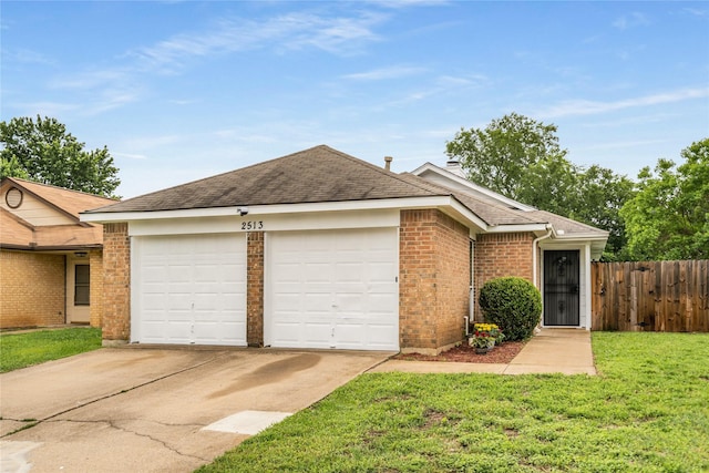 ranch-style house featuring a front lawn, fence, roof with shingles, concrete driveway, and an attached garage