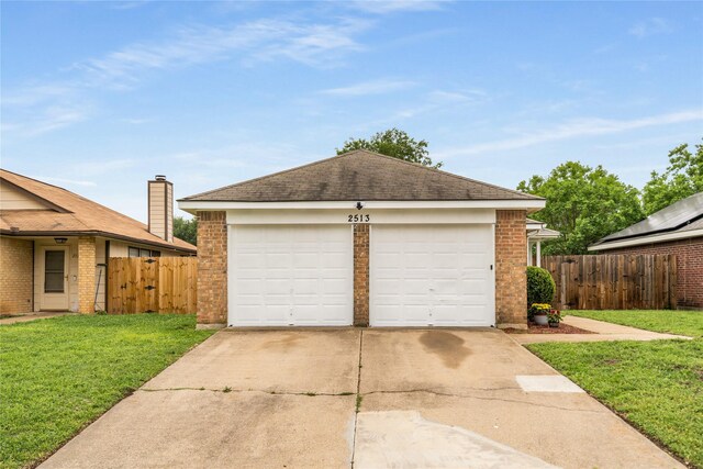 garage featuring fence, a gate, and concrete driveway