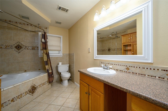full bathroom featuring visible vents, tile walls, tile patterned flooring, tiled shower / bath, and toilet