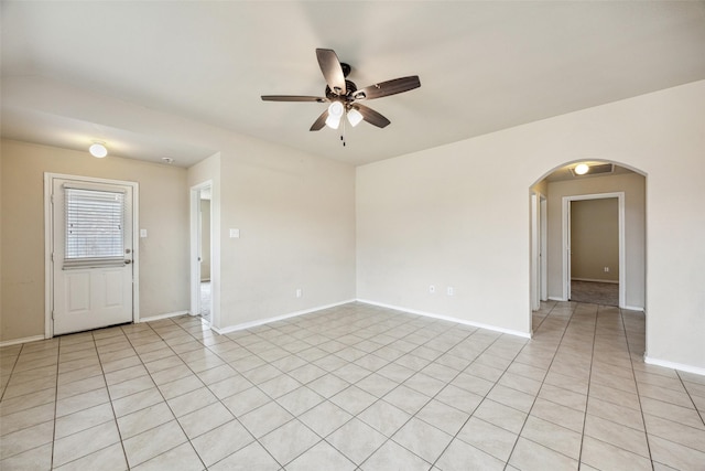994 Decker Dr, Fate, TX 75189 - unfurnished room with arched walkways, ceiling fan, light tile patterned floors, and baseboards