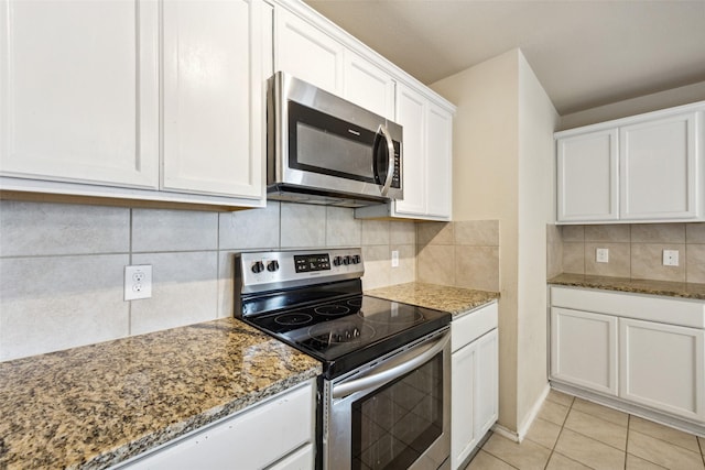 994 Decker Dr, Fate, TX 75189 - kitchen with stainless steel appliances, white cabinetry, stone countertops, tasteful backsplash, and light tile patterned floors