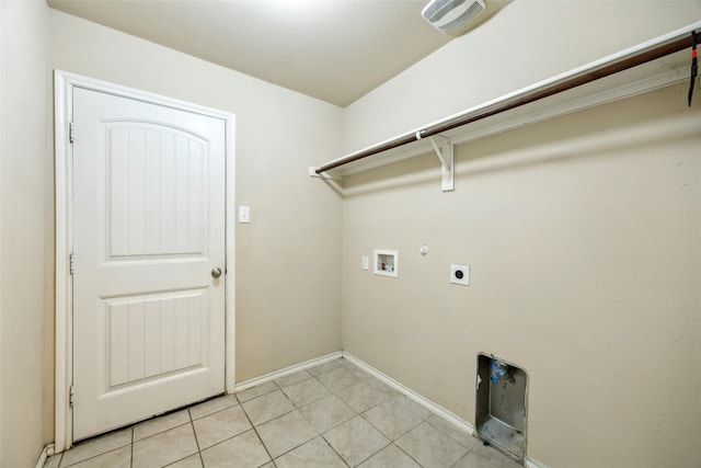 994 Decker Dr, Fate, TX 75189 - clothes washing area with washer hookup, electric dryer hookup, gas dryer hookup, light tile patterned floors, and baseboards