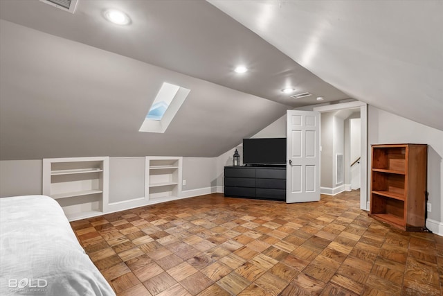 additional living space with vaulted ceiling with skylight, built in features, baseboards, and visible vents