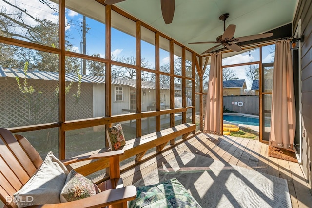 sunroom featuring a ceiling fan