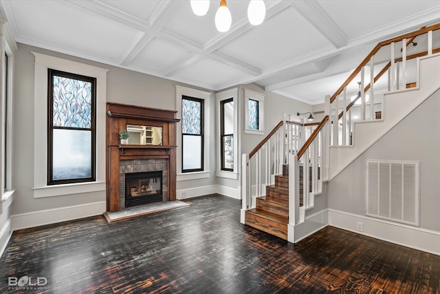 unfurnished living room featuring a fireplace, stairs, baseboards, wood finished floors, and visible vents