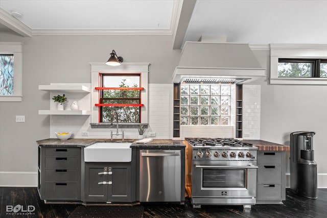 kitchen with custom range hood, a sink, gray cabinetry, dark wood-style floors, and stainless steel appliances