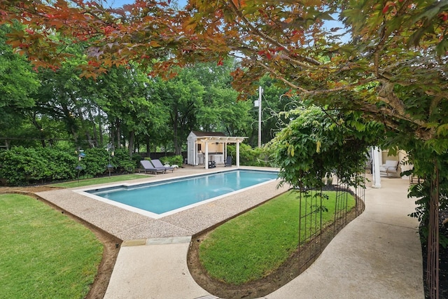 view of pool featuring an outdoor structure, a patio, an exterior structure, a fenced in pool, and a yard