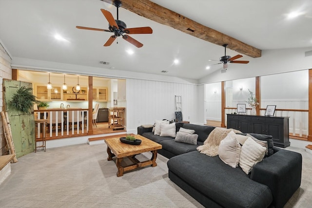 living area featuring visible vents, lofted ceiling with beams, ceiling fan, and light colored carpet