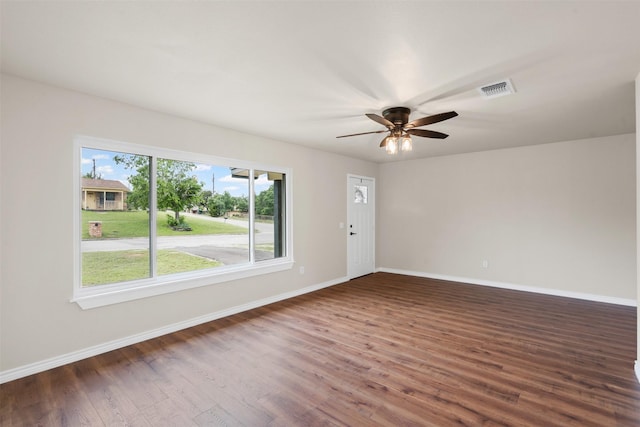 spare room with visible vents, baseboards, ceiling fan, and wood finished floors