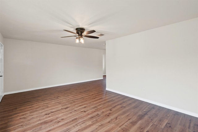 empty room with a ceiling fan, baseboards, and wood finished floors