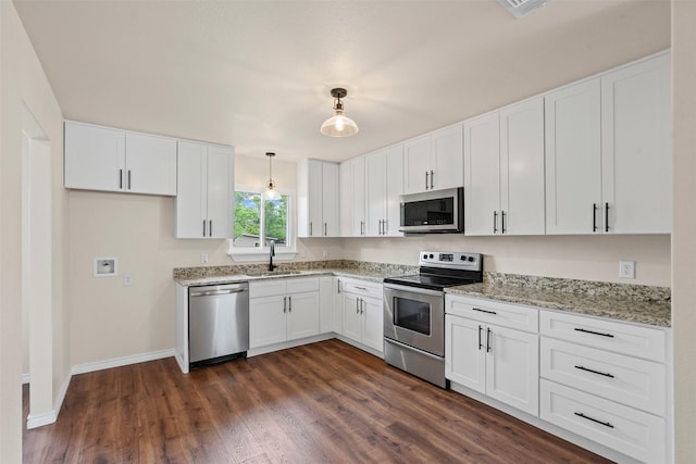 kitchen featuring white cabinets, appliances with stainless steel finishes, and a sink