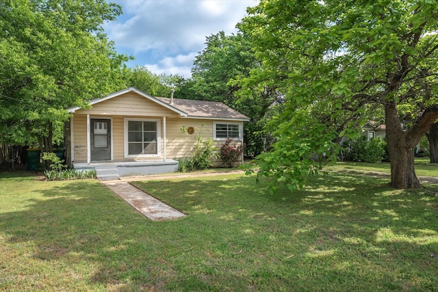 bungalow-style house with covered porch and a front yard