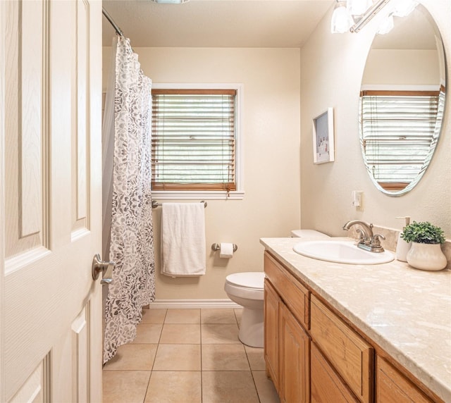 full bathroom featuring vanity, baseboards, tile patterned floors, and toilet
