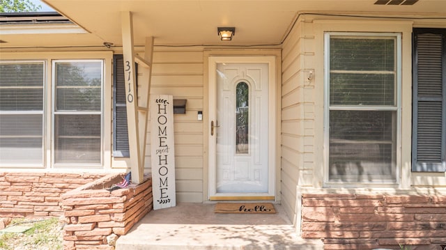 doorway to property featuring stone siding