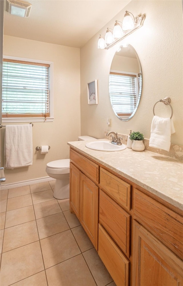 bathroom with visible vents, tile patterned flooring, vanity, baseboards, and toilet