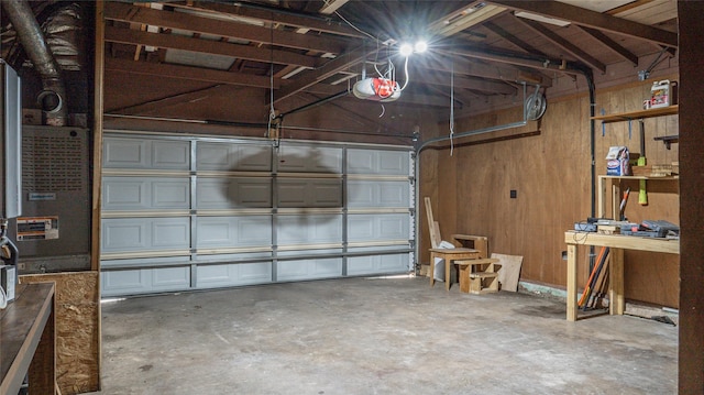 garage with wood walls and a garage door opener