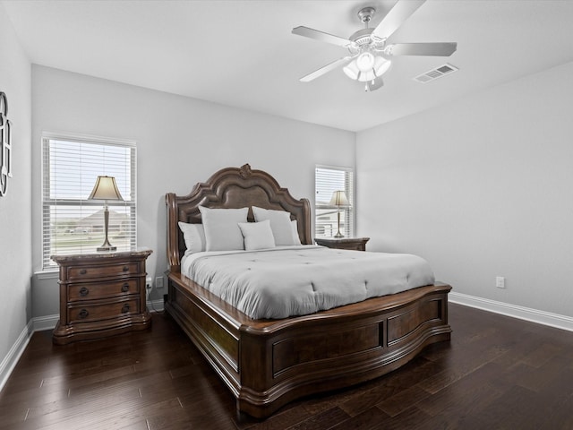 bedroom with visible vents, baseboards, and wood finished floors