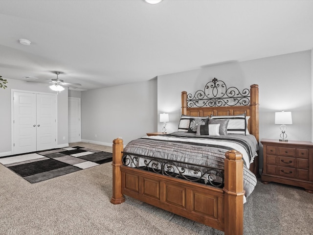 carpeted bedroom featuring a ceiling fan, baseboards, and a closet
