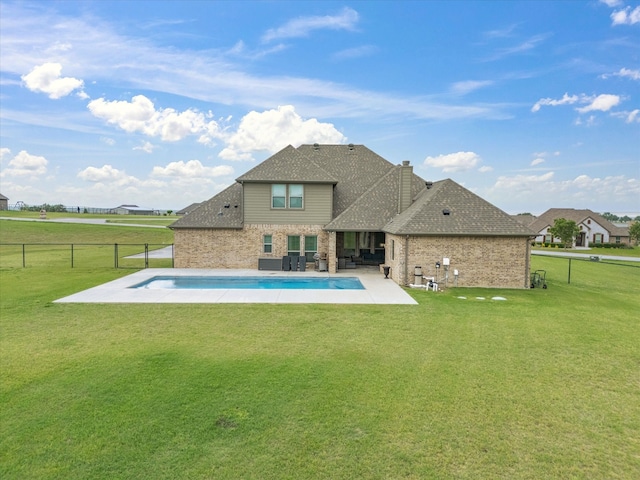 back of house featuring a fenced backyard, a patio, and a yard