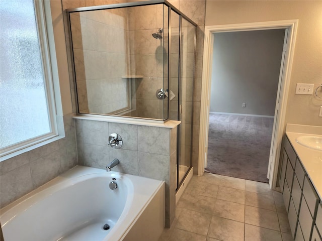 10076 Travis Dr, Providence Village, TX 76227 - bathroom with vanity, tile patterned flooring, a garden tub, and a stall shower