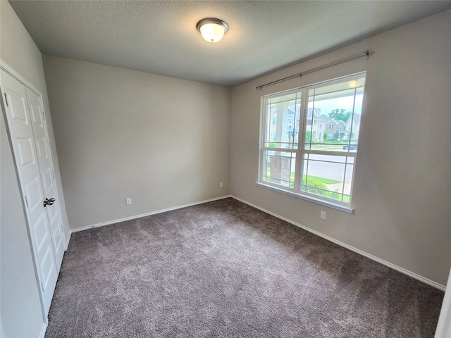 10076 Travis Dr, Providence Village, TX 76227 - unfurnished bedroom featuring baseboards, carpet, and a textured ceiling