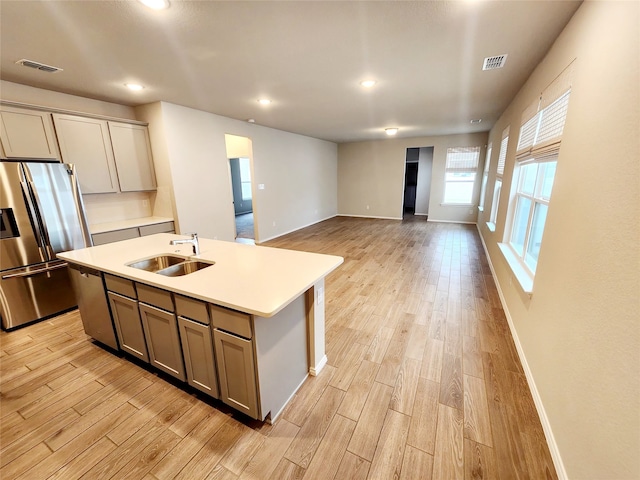 10076 Travis Dr, Providence Village, TX 76227 - kitchen with a sink, stainless steel appliances, light wood-style flooring, and visible vents