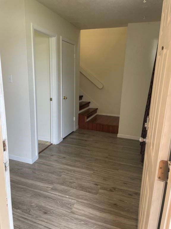 interior space featuring baseboards and wood finished floors