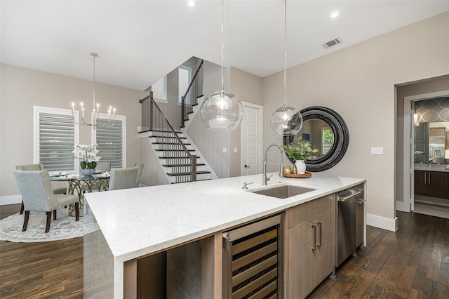 kitchen with visible vents, a sink, beverage cooler, a notable chandelier, and an island with sink