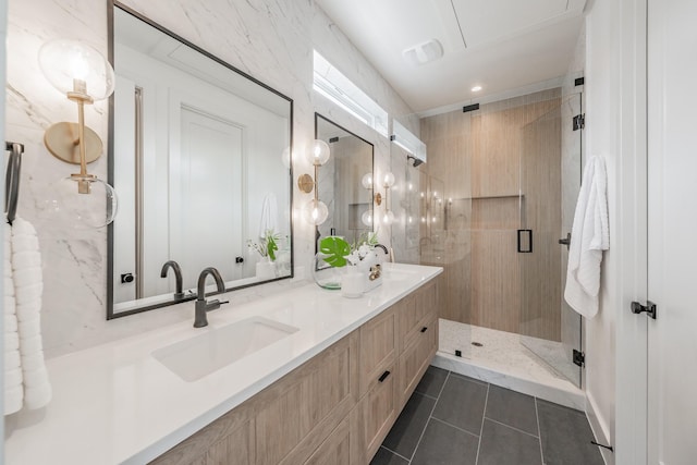 bathroom featuring double vanity, a sink, tile patterned floors, and a shower stall