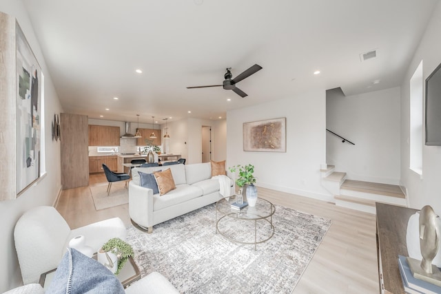 living area featuring recessed lighting, a ceiling fan, light wood-type flooring, visible vents, and stairway