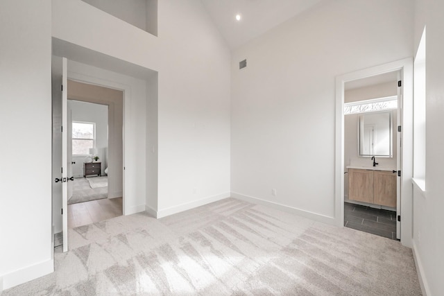 unfurnished bedroom with visible vents, carpet flooring, baseboards, and connected bathroom