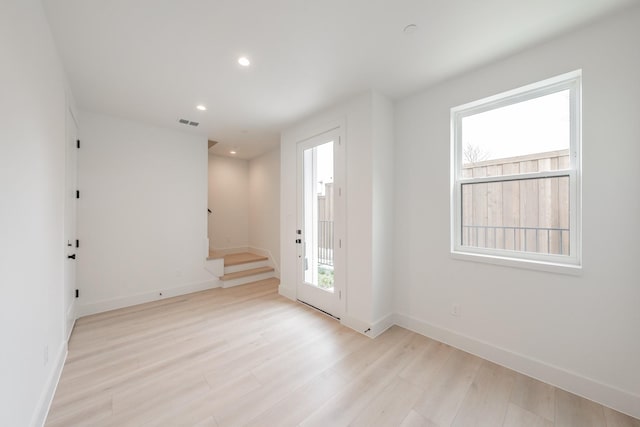 entryway with visible vents, stairway, baseboards, light wood finished floors, and recessed lighting
