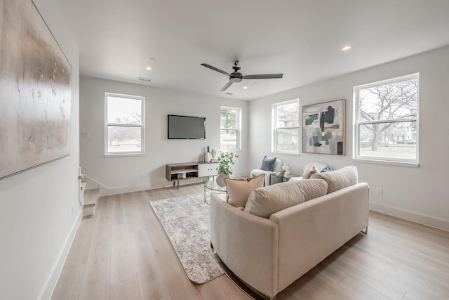 living room featuring a ceiling fan, baseboards, and recessed lighting