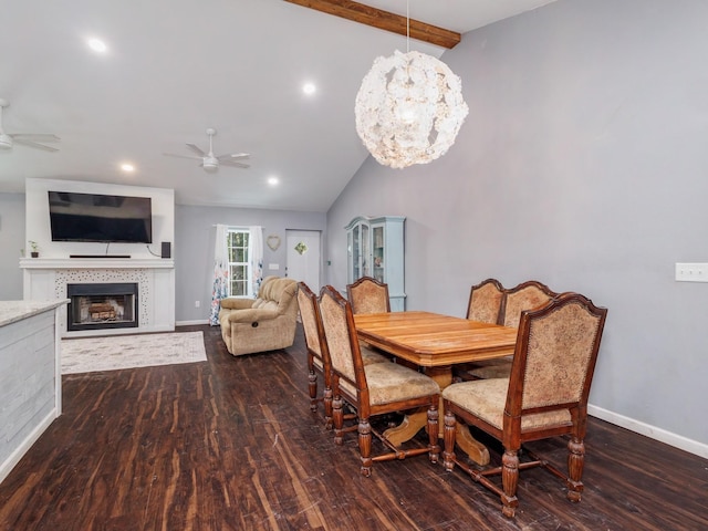 dining space with dark wood-type flooring, a ceiling fan, and lofted ceiling with beams