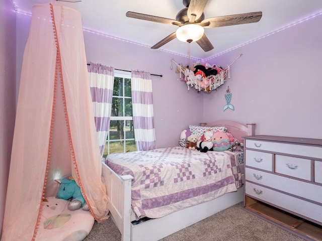bedroom featuring a ceiling fan and carpet