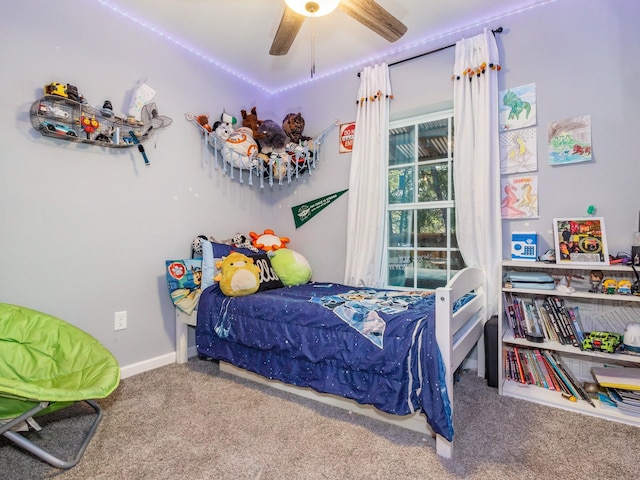bedroom with carpet floors, a ceiling fan, and baseboards