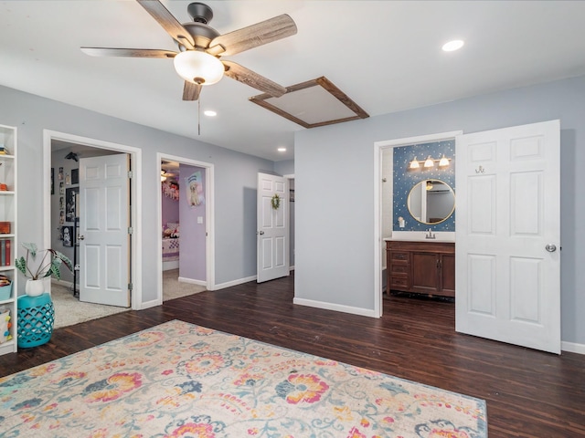 bedroom with connected bathroom, recessed lighting, baseboards, and wood finished floors