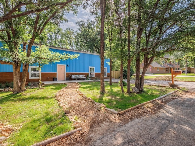 view of property's community with a yard and an outbuilding