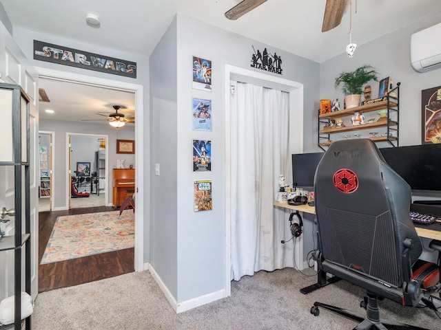carpeted home office with a ceiling fan, baseboards, and a wall mounted air conditioner