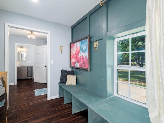 mudroom with baseboards and dark wood-type flooring