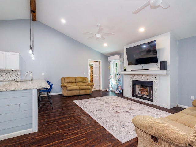 living room featuring lofted ceiling with beams, a ceiling fan, and dark wood-style flooring