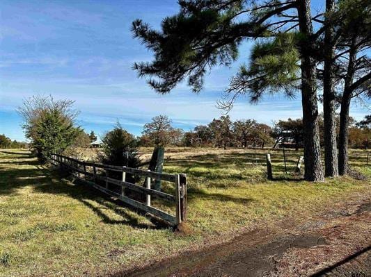 view of yard featuring fence and a rural view