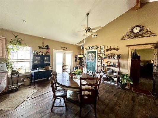 dining area featuring french doors, a ceiling fan, visible vents, high vaulted ceiling, and dark wood-style floors